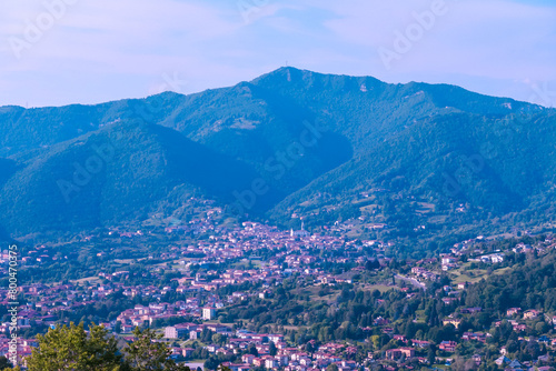 Aerial view of historic medieval walled city of Bergamo seen from Città Alta (Upper Town), Lombardy, Northern Italy, Europe. Alpine landscape of Italian Alps, historical buildings and the towers