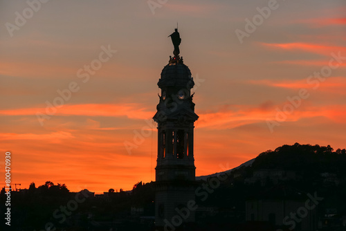 Scenic sunset view of tower of  church Chiesa di Sant Alessandro della Croce the town of Bergamo  Lombardy  Northern Italy  Europe. Romantic atmosphere in historical old town. Silhouette of buildings