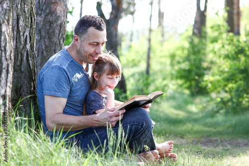 father and child reading the bible