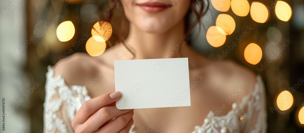 Closeup woman bride holding empty blank business card in hands, mockup with copy space.