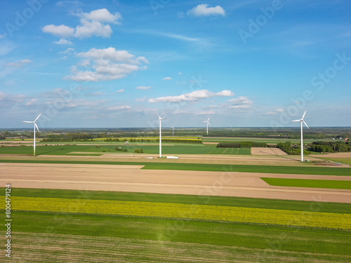 Spring farmland and electric windmills.