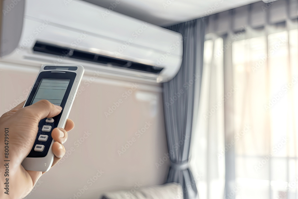 Close-up of Hand Using Remote to Adjust Temperature on Wall Air Conditioner unit Close-up of Hand Using Remote to Adjust Temperature on Wall Air Conditioner unit
