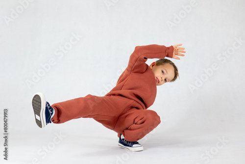 A little boy in a breakdance position. A little boy is breakdancing.