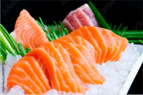Fresh salmon and tuna sashimi delicately sliced and garnished with green onions and sesame seeds. Bright fish pieces rest on ice, radiating freshness and the appetizing scent of the sea.