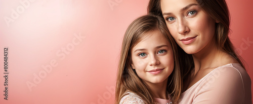 Portrait of a Caucasian mother and daughter on a red background with copy space for text. World Mother's Day concept design for holidays, family love, motherhood celebration