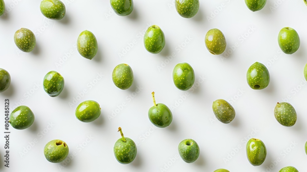 green olives scattered on a neutral background green olives scattered on a neutral background