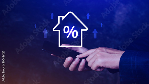 Real estate property investment concept  Asset management  Interest rates  inflation  loan mortgage  increase tax. Hand holding house icon with percent and rise arrow.