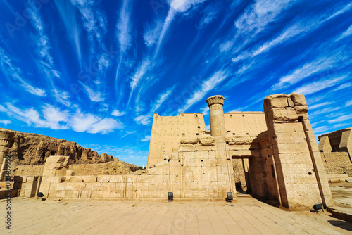 Beautiful bright blue skies and wispy cloud patterns over the atmospheric temple of Kom Ombo dedicated to crocodile goddess Sobek and Haroeris built by Ptolemy pharoahs in Kom Ombo,Near Aswan,Egypt photo