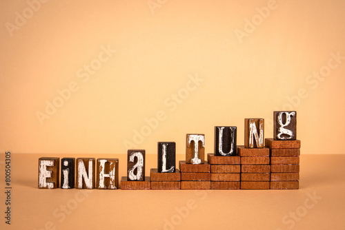 Compliance word in German. Wooden alphabet letters on a light background © STOATPHOTO