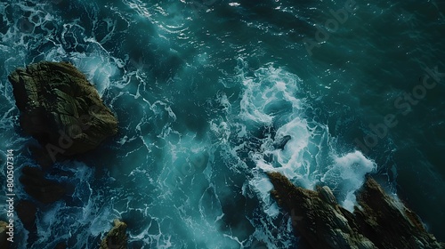 Aerial view of rocks and aquamarine sea waves