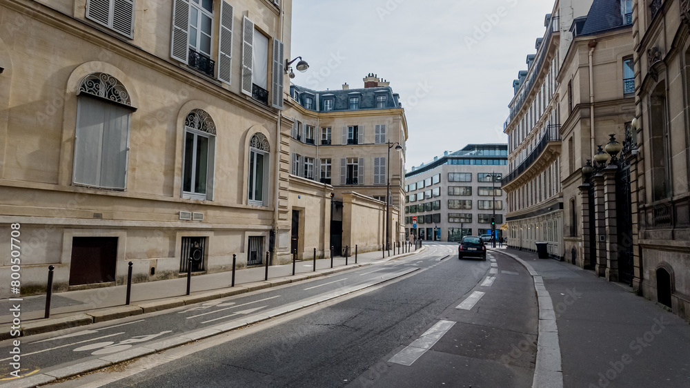 Quiet Parisian street with classic architecture on a cloudy day, ideal for travel themes and European cityscapes