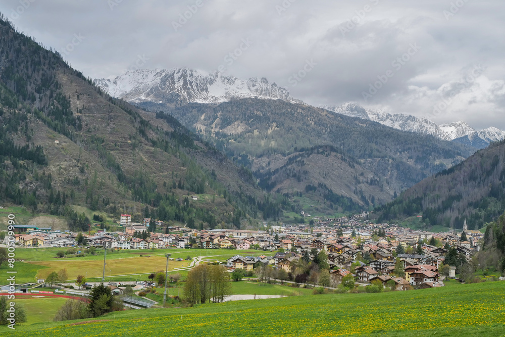 Panoramic view of Predazzo. Val di Fiemme in Trentino Alto Adige. The snow-capped Latemar mountain in the background of Predazzo. Spring