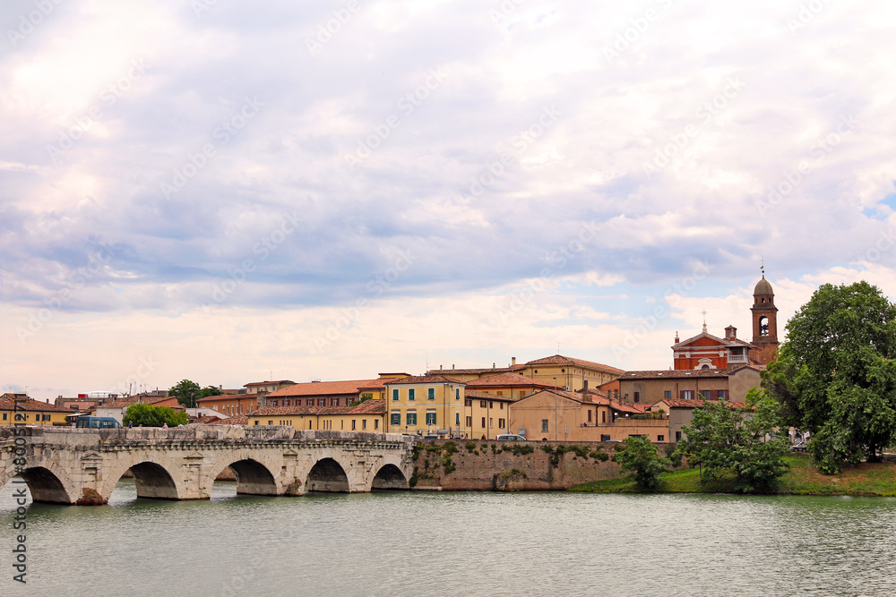 Obraz premium Tiberius bridge and old town buildings cityscape in Rimini Italy