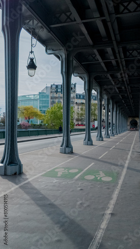 Elegant urban scene with a symmetric view of a bicycle lane under a vintage-style colonnade, perfect for topics related to urban planning and sustainable transportation photo