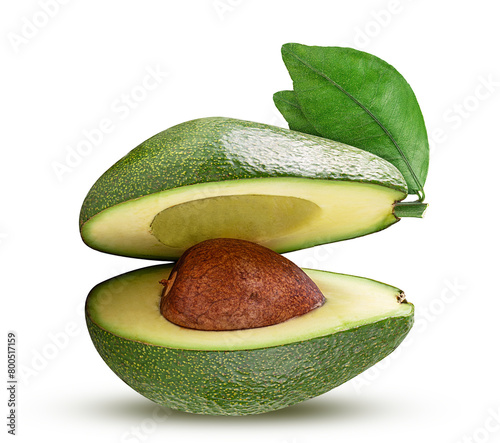 Whole avocado cut in half with green leaf