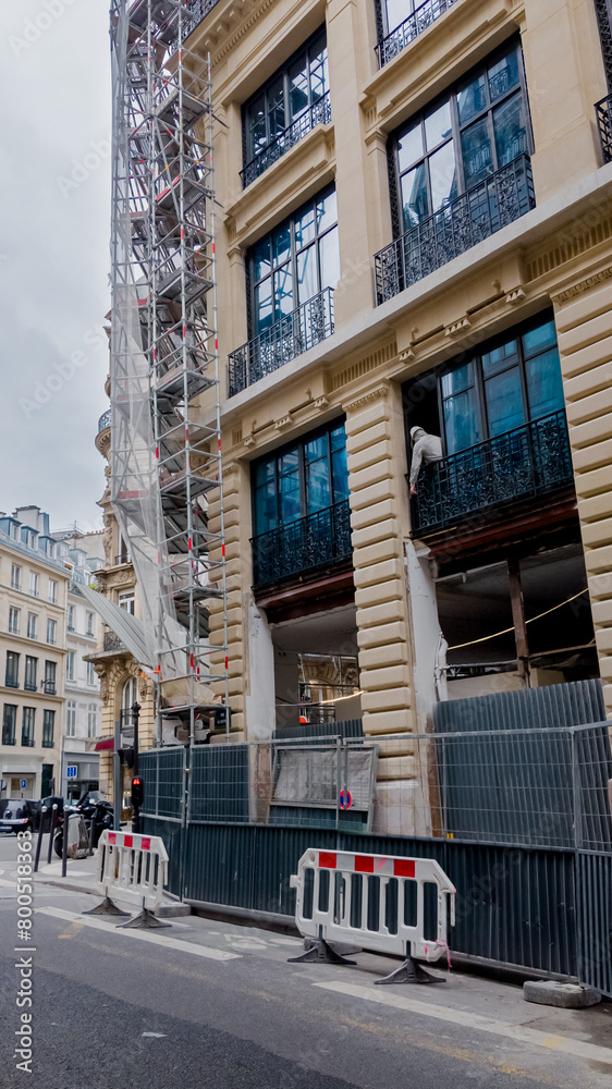 Paris, France, April 14th, 2024 European city street with traditional architecture and construction scaffolding, symbolizing urban development and renovation