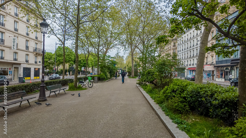 Tranquil urban park in spring with fresh greenery, walking pedestrians, and classic streetlamps, evoking concepts of Earth Day and urban sustainability Tranquil urban park in spring with fresh greenery, walking pedestrians, and classic streetlamps, evoking concepts of Earth Day and urban sustainability