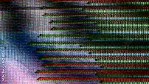 Full frame lockdown footage of various abstract multicolored pixelated CRT glitches moving speedily on screen