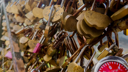 Принти на полотні Assorted love padlocks attached to a bridge railing symbolizing eternal love and