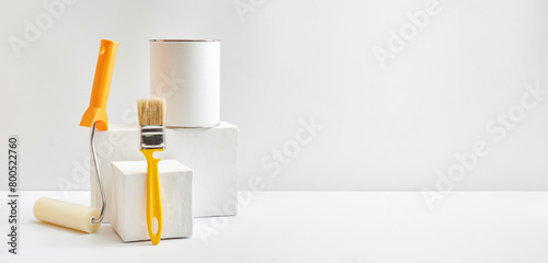 Foto Geometric podium or pedestal with paint can, brush, sponge roller on a white background