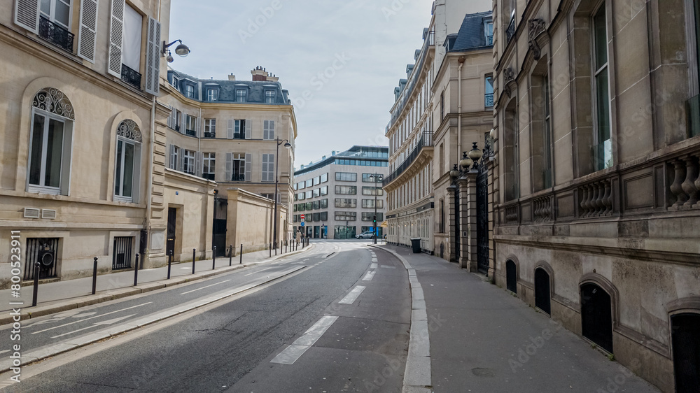 Deserted urban street in Paris with classical architecture, perfect for themes like city lockdown, early morning calm, or European travel