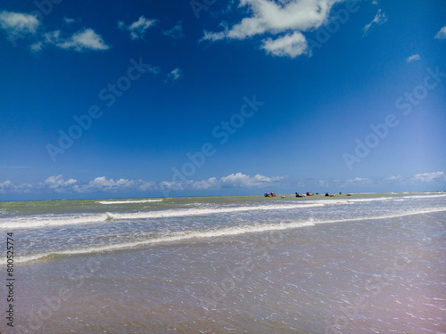 View of the waves of a turquoise sea reaching the seashore, resting place on Brazil beach, Rio Grande do Norte, 