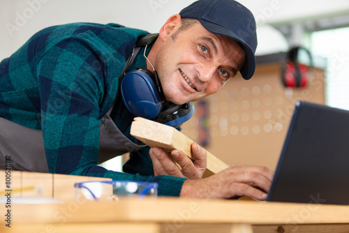 фотографія mature carpenter focused on planning woodworking project