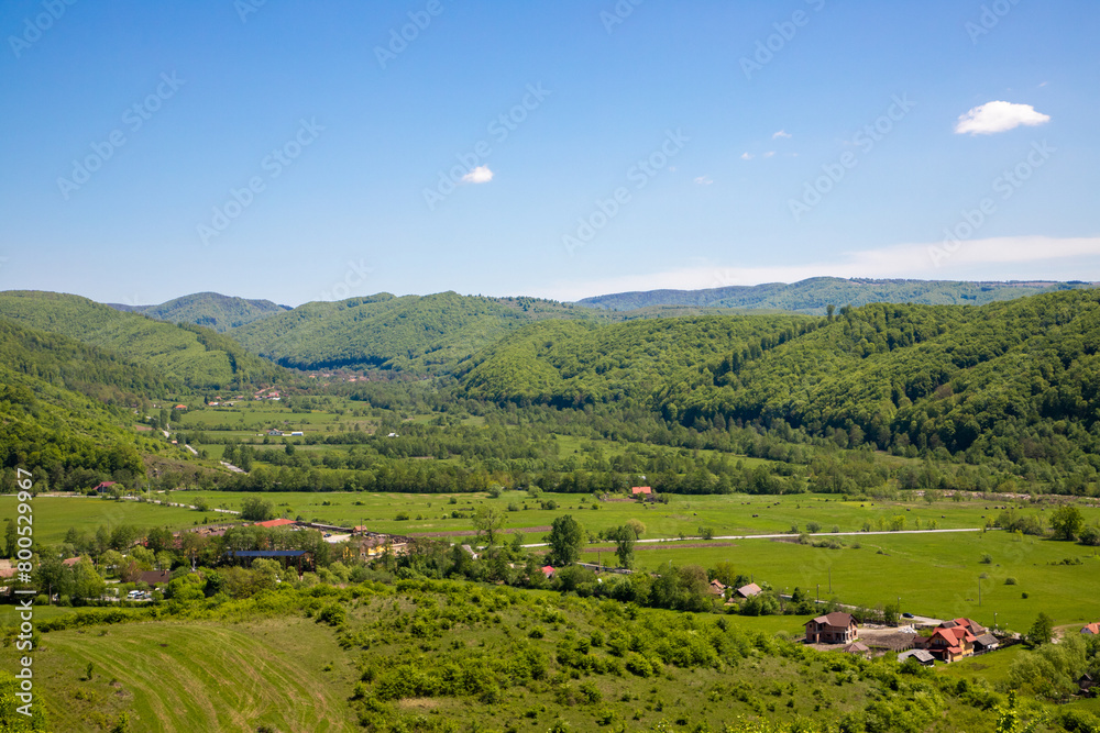 Landscape with a countryside area from Tranilvania - Romania. Aerial view of a rural area with hills, valleys and houses from the Eastern Europe