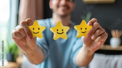 A photo of a person holding two stars.