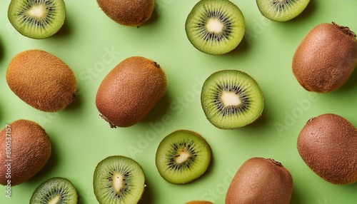 Kiwi pattern on pastel background, top view. Flat lay with fresh green kiwi slices. Minimal summer concept