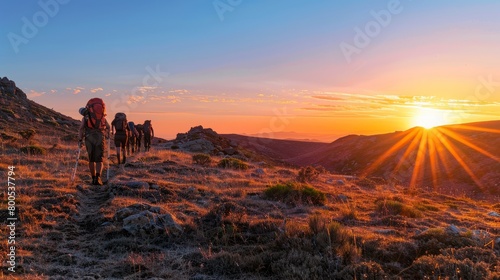 Adventurers Hiking Towards Sunset on Mountain Trail