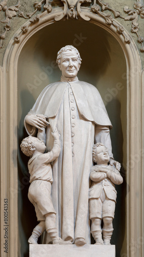 VICENZA, ITALY - NOVEMBER 6, 2023: The carved statue of St. Don Bosco in the church Chiesa di San Gaetano by  Orazio A. Marzari (1999). photo