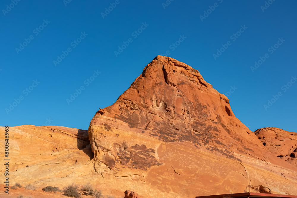 Panoramic sunrise view of one of group of seven tall, red, Aztec Sandstone Rock eroded boulders called Seven Sisters in Valley of Fire State Park in Mojave desert near Overton, Nevada, USA. Road trip