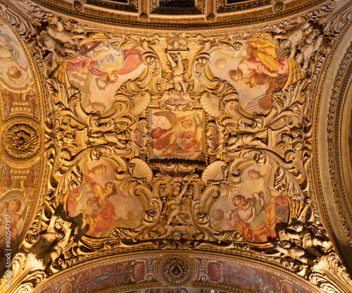 MILAN, ITALY - MARCH 5, 2024: The baroque ceiling with the frescoes (early christian women - martyrs) in the side nave of church Chiesa di San Vittore al Corpo.  photo