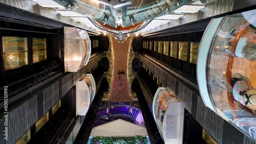 Directly above lockdown footage of people in elevators of modern cruise ship