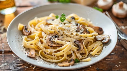 A gourmet pasta dish adorned with porcini mushrooms and shaved Parmesan cheese, a culinary masterpiece inspired by nature's bounty.
