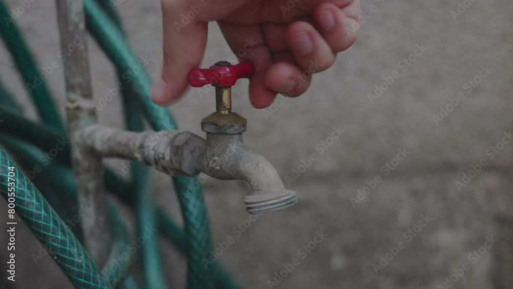 Hand of a person turning on the water faucet without water during a shortage. water crisis concept