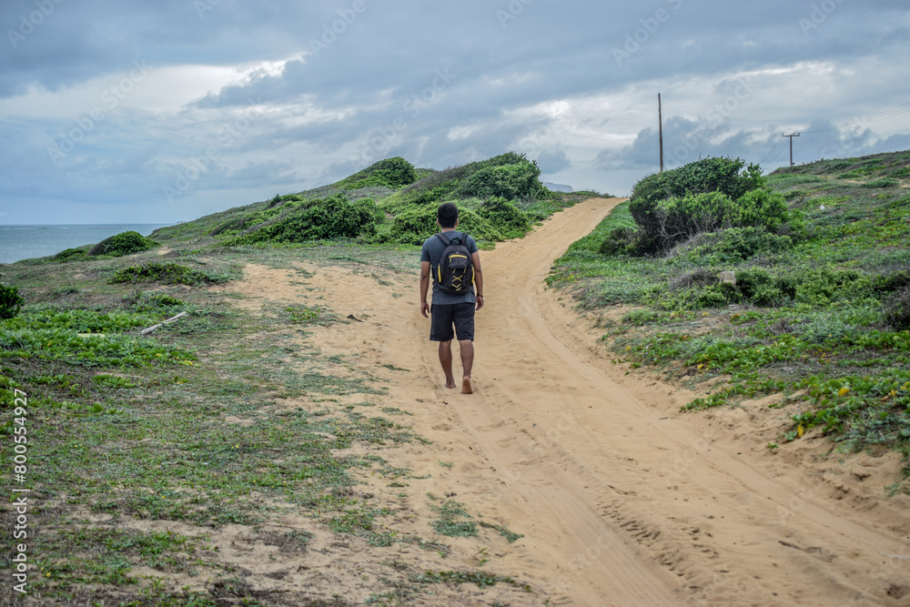 Fototapeta premium Man traveler walking alone on the beach travel lifestyle active summer vacations outdoor sea view 