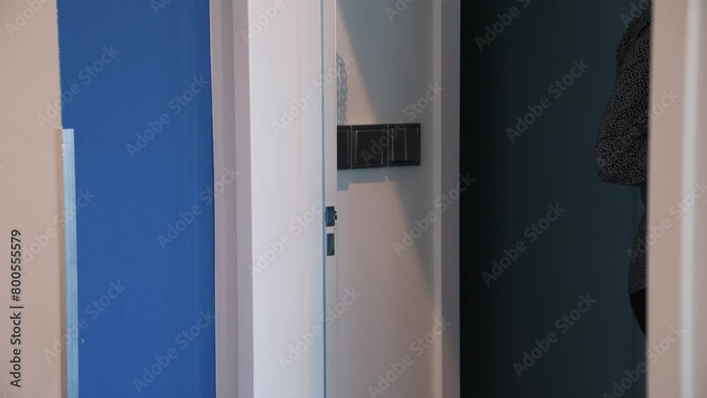 Girl opens door to room with an electronic key. Secure key card system in the hotel. Vacation at the hotel. Safe lock modern technology. Electronic access to office. Business office secure entrance