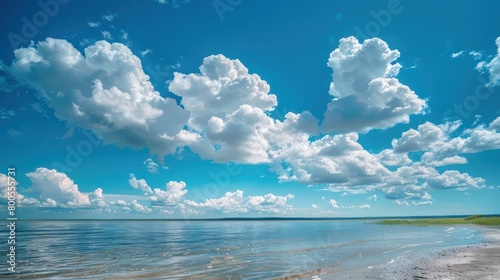 A vibrant beach setting with a clear view of the ocean edged by a beautiful beach and a dynamic cloudscape photo