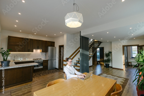 Woman working in modern private home interior