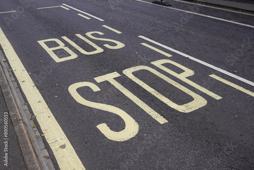 Bus Stop sign painted on road. bus lane markings. public transport  photo