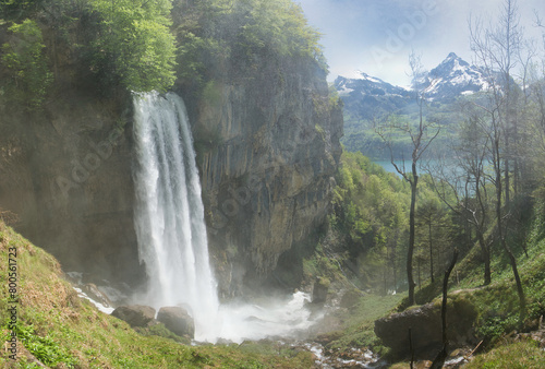 The Seerenbach Falls in spring with lots of water and a blue sky