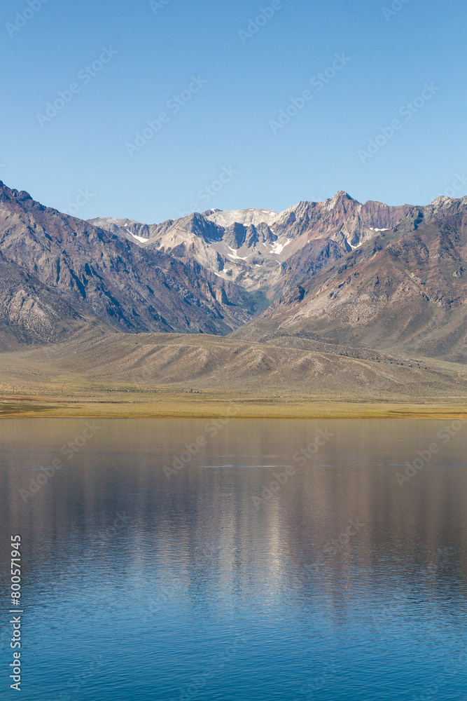 panoramic view over the Crowley lake to a iconic mountain range at a bright sunny summer day, California