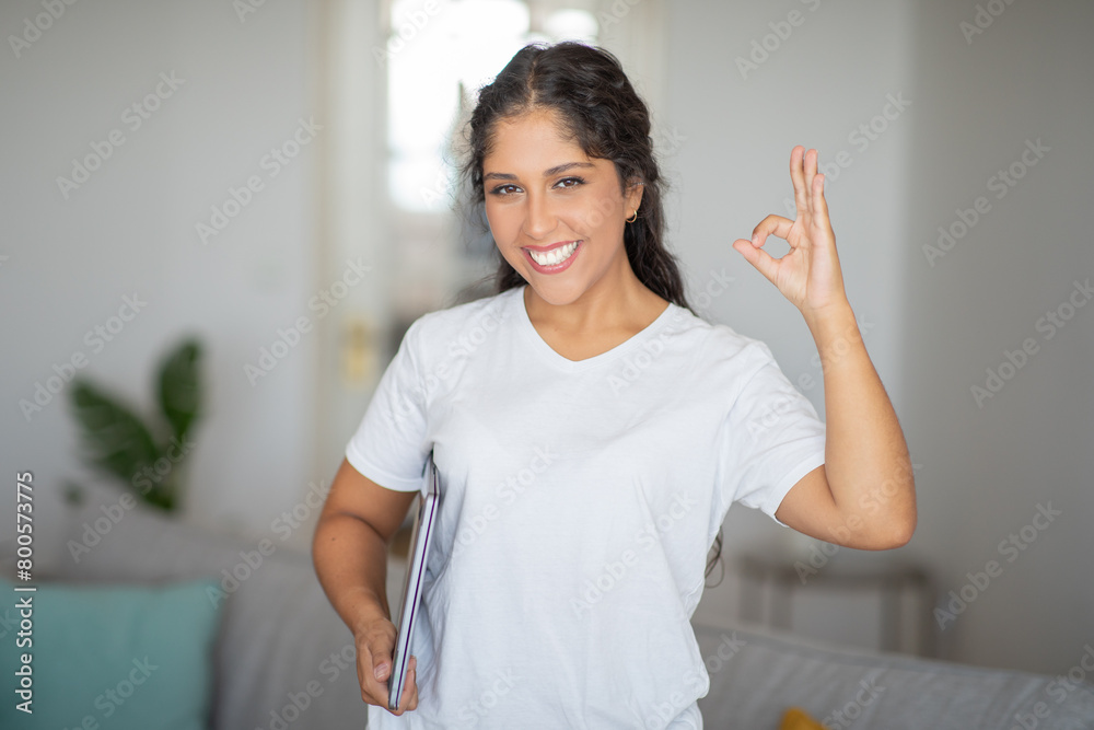 Woman Holding White Folder, Showing Okay Gesture Woman Holding White Folder, Showing Okay Gesture