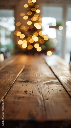 a wooden table with a christmas tree in the background