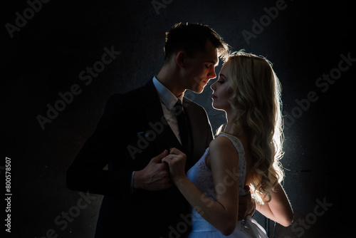 Art fashion studio photo of wedding couple silhouette groom and bride on colors background. Art Wedding style.