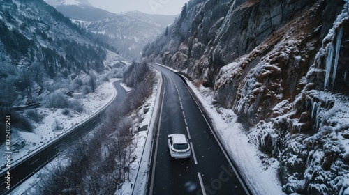 Aerial view white car drive in winter asphalt highway at mountain landscape background. Generate AI