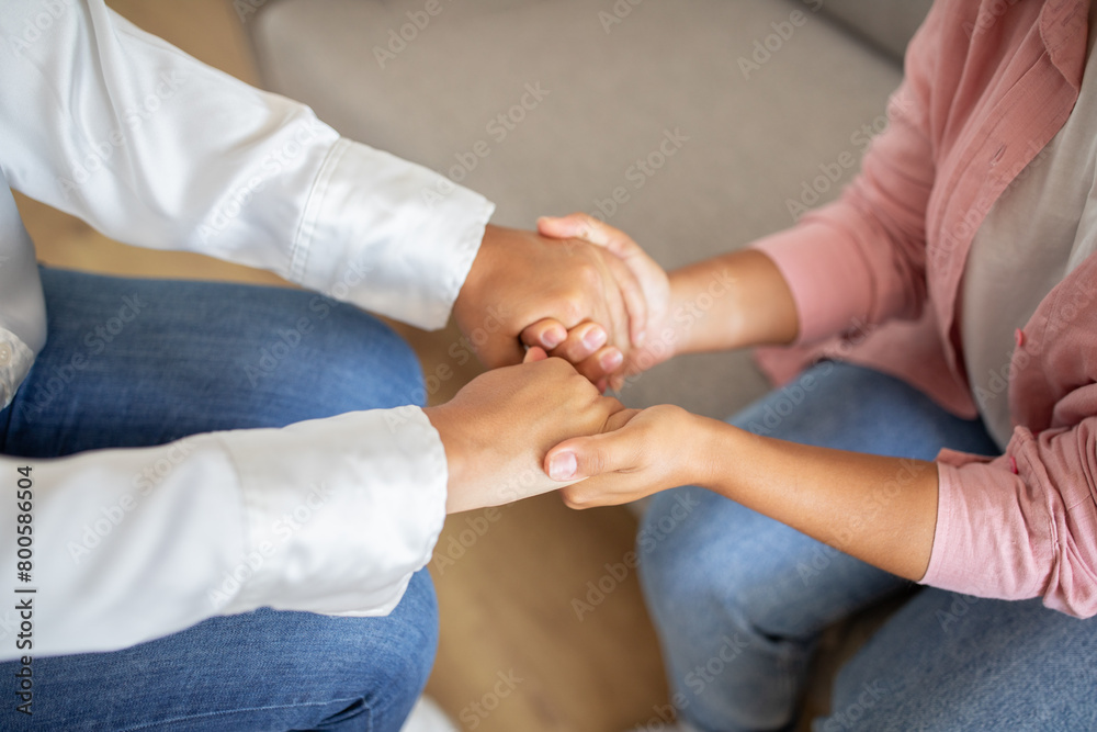 Cropped of young woman holding her therapist hands and smiling Cropped of young woman holding her therapist hands and smiling
