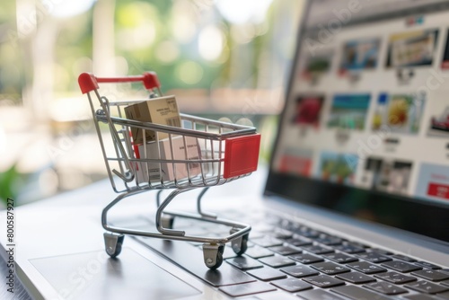 A shopping cart is displayed on a laptop screen. The cart is filled with items, including a bottle and a box. Concept of convenience and modernity